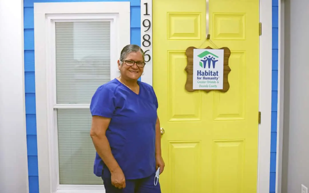 A woman smiles at the camera