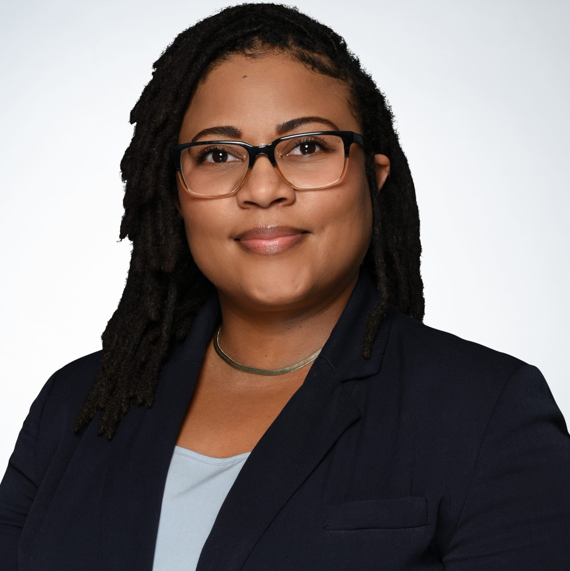 Business woman smiling at camera in front of white background