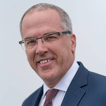 Business man smiling at camera in front of white background