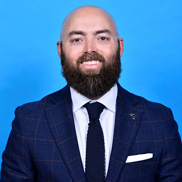 Business man smiling at camera in front of white background