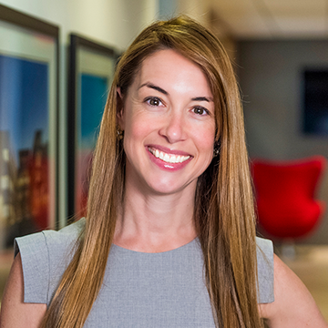 Business woman smiling at camera in front of white background