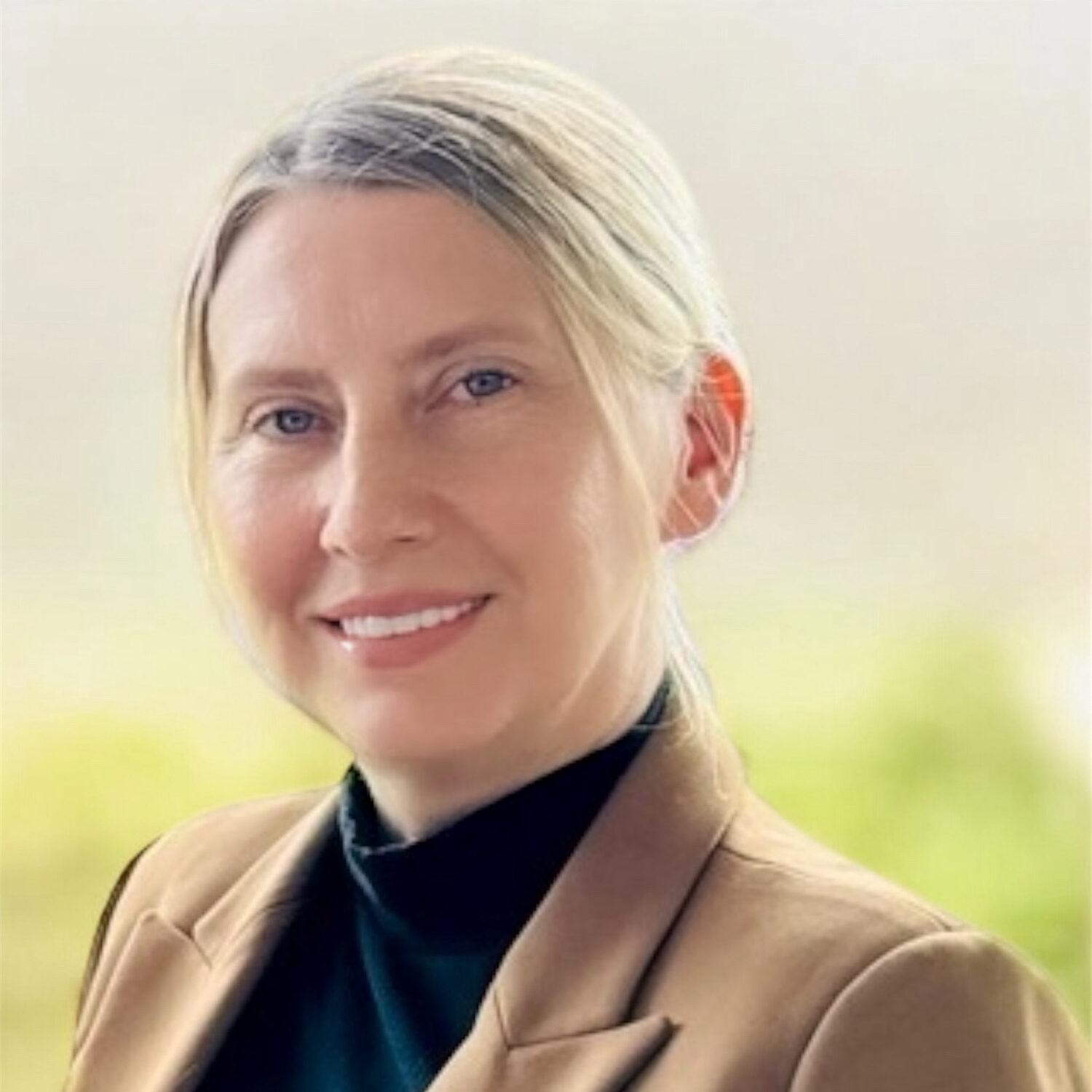 Business woman smiling at camera in front of white background