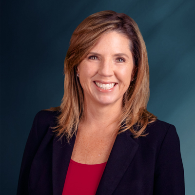 Business woman smiling at camera in front of white background