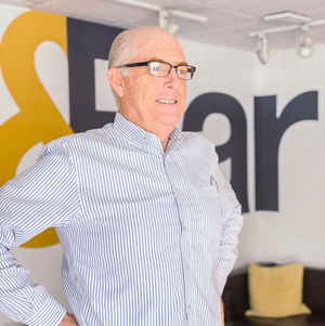 Business man smiling at camera in front of white background