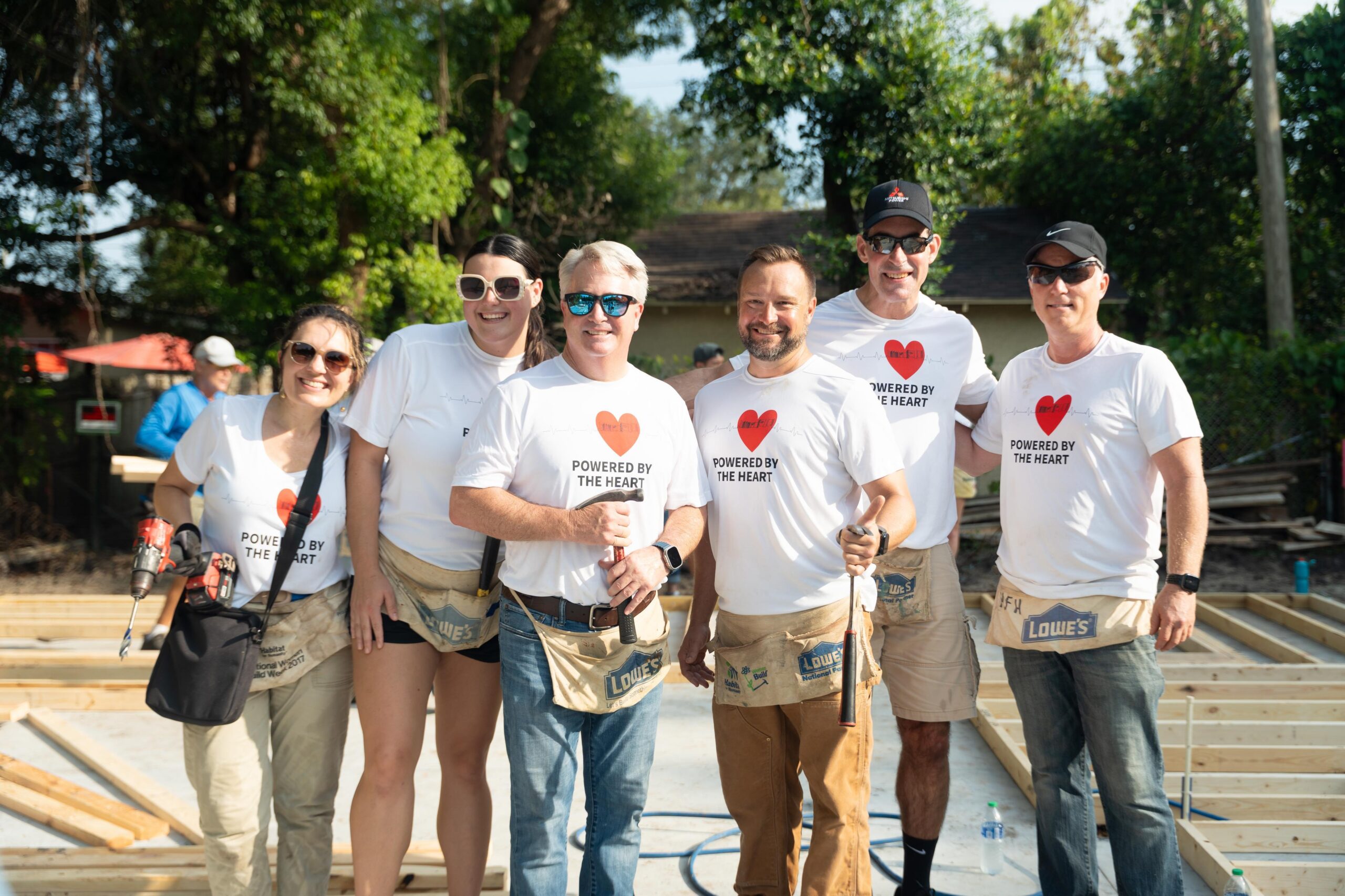 Close-up of golden hammers on top of black Bibles on blue tablecloth