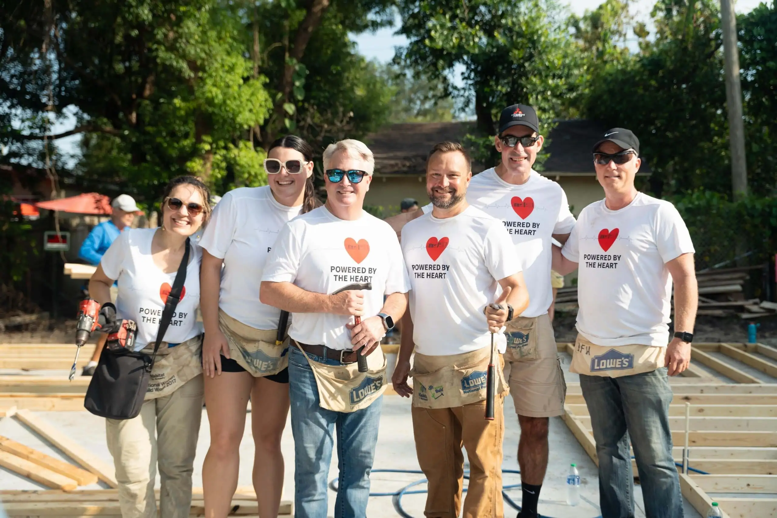 Close-up of golden hammers on top of black Bibles on blue tablecloth